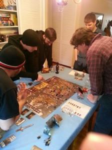 Players standing around the game. It's exciting.